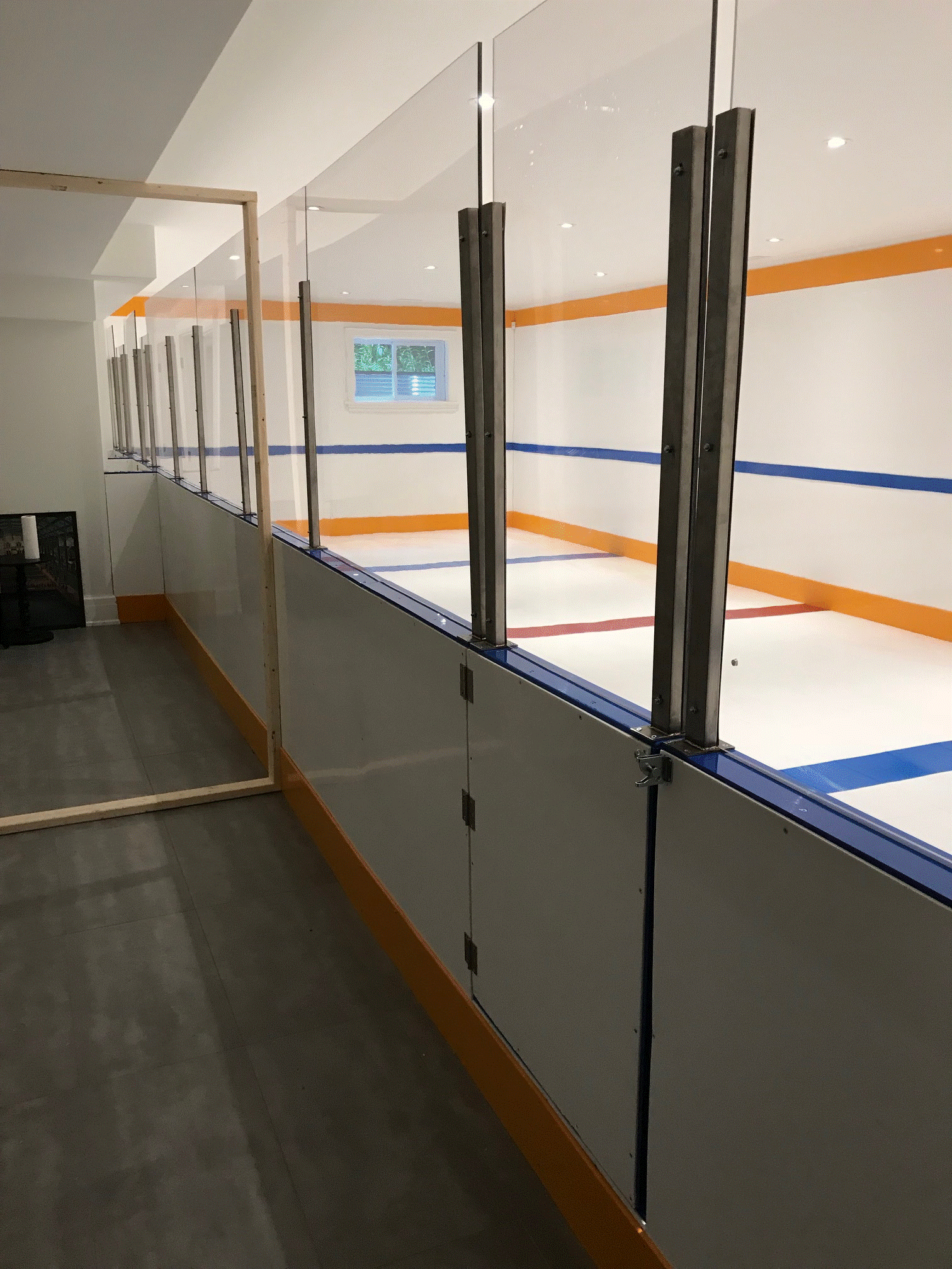 Basement rink with inline tiles and plexi-glass shielding