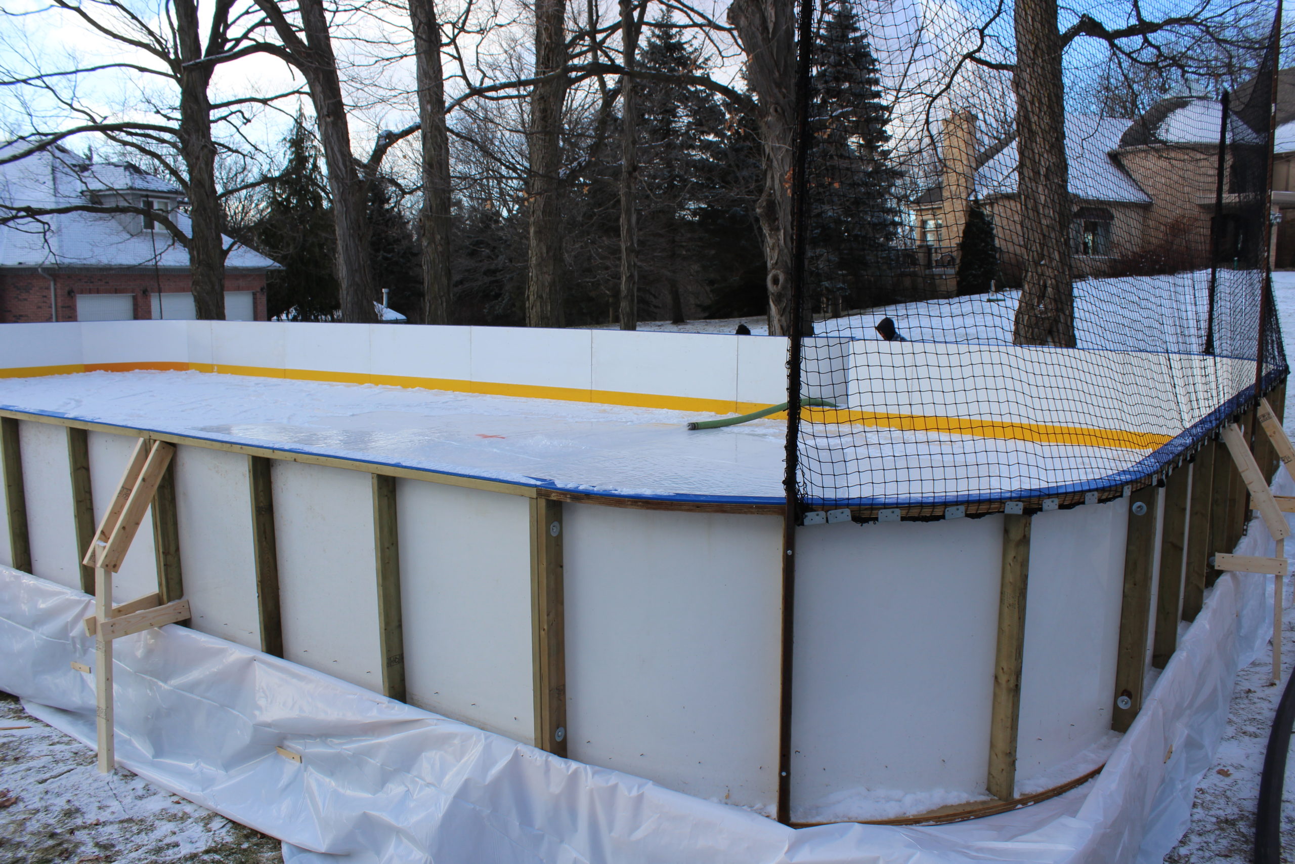 Portable ice rink with subfloor and dasher boards